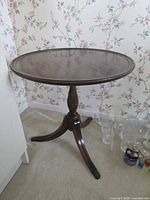 Full view of mahogany round pedestal side table showing tripod base