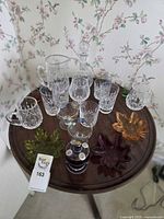 Overhead view showing full assortment of crystal pieces, colored dishes, coupes, lidded jar and shot glasses