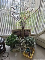 Full view of metal vase with faux cherry blossom branches