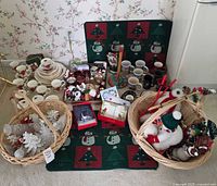 Overview of teacup trio with numerous Christmas decorations in baskets