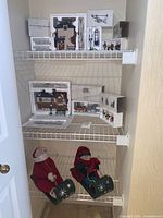 Overall view of lot on three wire shelves including buildings, accessories and plush figures