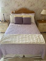 Bed showing rattan headboard, lavender bedding set and pillows