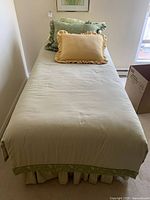 Full view of twin bed with bedding