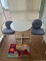 Full view of table, two chairs, and doormat