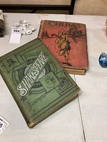 Top view of both antique books showing covers and wear