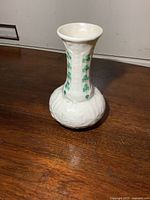 Full view of Belleek vase showing shamrock design and bulbous base