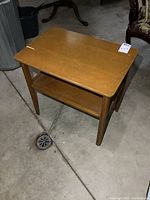 Full view of wooden end table showing overall design and lower shelf
