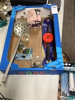 Overview of box contents including rod, scoop, tackle packaging