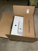 Boxed American Standard sink showing brand on carton