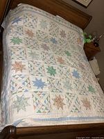 Full view of quilt on bed showing overall pattern and size