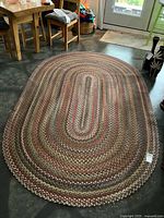 Full view of braided oval rug on floor