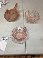 Group view: hen dish, teacup with saucer, footed bowl