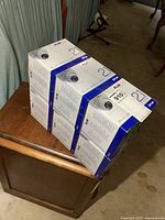 Six sealed boxes of Flir MPX security cameras stacked