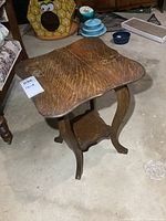 Full view of oak side table showing top, legs, lower shelf