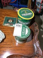 All three tins on wooden table