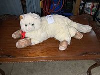 Full view of plush cat on table