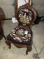 Full view of carved wood needlepoint chair front