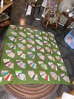 Full view of quilt spread on floor showing overall design and colour