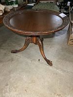 Full view of round carved wood coffee table