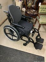 Side view of black X Core wheelchair showing frame, seat and wheels