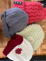 Four knit beanies in various colours and textures