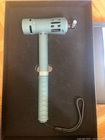 Percussion massage gun in fitted box showing overall condition