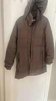 Full front view of Helly Hansen brown puffer parka with hood
