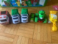 All six toy vehicles lined up front angle
