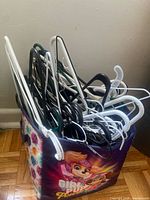 Bag filled with assorted plastic clothes hangers