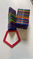 Stacked magnetic square frames, stack of triangular frames, red pentagon frame displayed