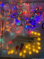 Overview of string lights, LED tea lights, gold tapers and wax candles