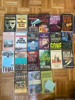 Overall shot of 21 assorted paperback novels laid out in four rows