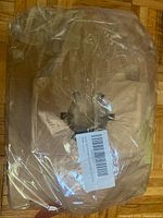 Sealed stack of flat kraft muffin boxes showing die-cut window and barcode label