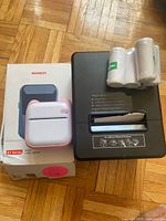 NIIMBOT printer box, NIIMBOT printer, MUNBYN printer and five sealed paper rolls