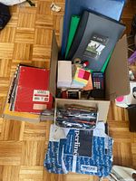 Top view of box showing notebooks, binders, copy paper, pencil case and supplies