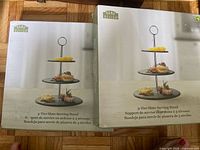 Front view of two boxed Rama Design 3-tier slate serving stands