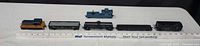 All six HO scale B&O / Chessie System rolling stock items lined up with ruler for scale