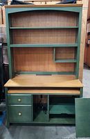 Front view of complete desk and hutch showing shelves and base