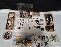 Overall view of all miniature figures, animals, wagons and storage containers
