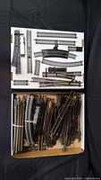 Two boxes filled with assorted straight, curved and switch HO track pieces