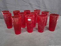 Group shot of 12 red crinkle glass cups standing upright