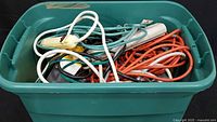 Tote filled with mixed extension cords and power strips