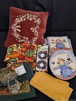 All items overview including pillow, placemats, napkins, plates, candle items