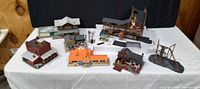 Front view of all HO scale buildings and accessories laid out on table