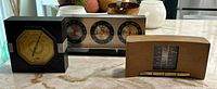 All three vintage weather instruments on countertop