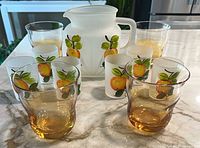 Entire lot showing pitcher, six frosted fruit glasses and two of the amber-clear wavy tumblers