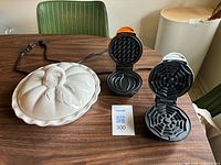 All three items displayed; dish closed, waffle makers open showing plate patterns