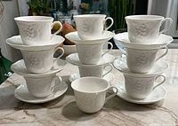White Wedgwood Strawberry Vines teacups and saucers stacked to show full quantity and condition