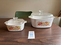 Both casseroles with lids displayed on table