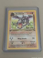 Front of Aerodactyl prerelease 1st edition card in protective holder